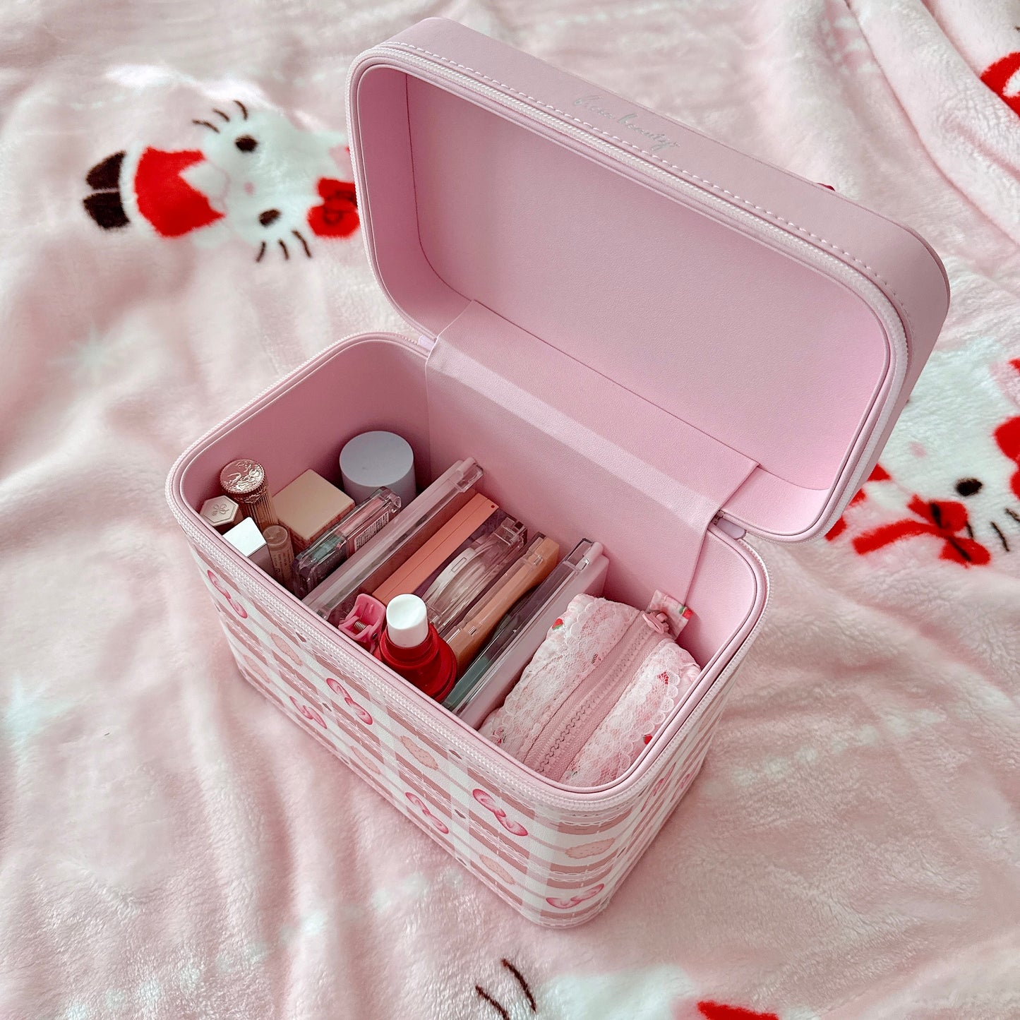 Pink cosmetic case filled with organized makeup.