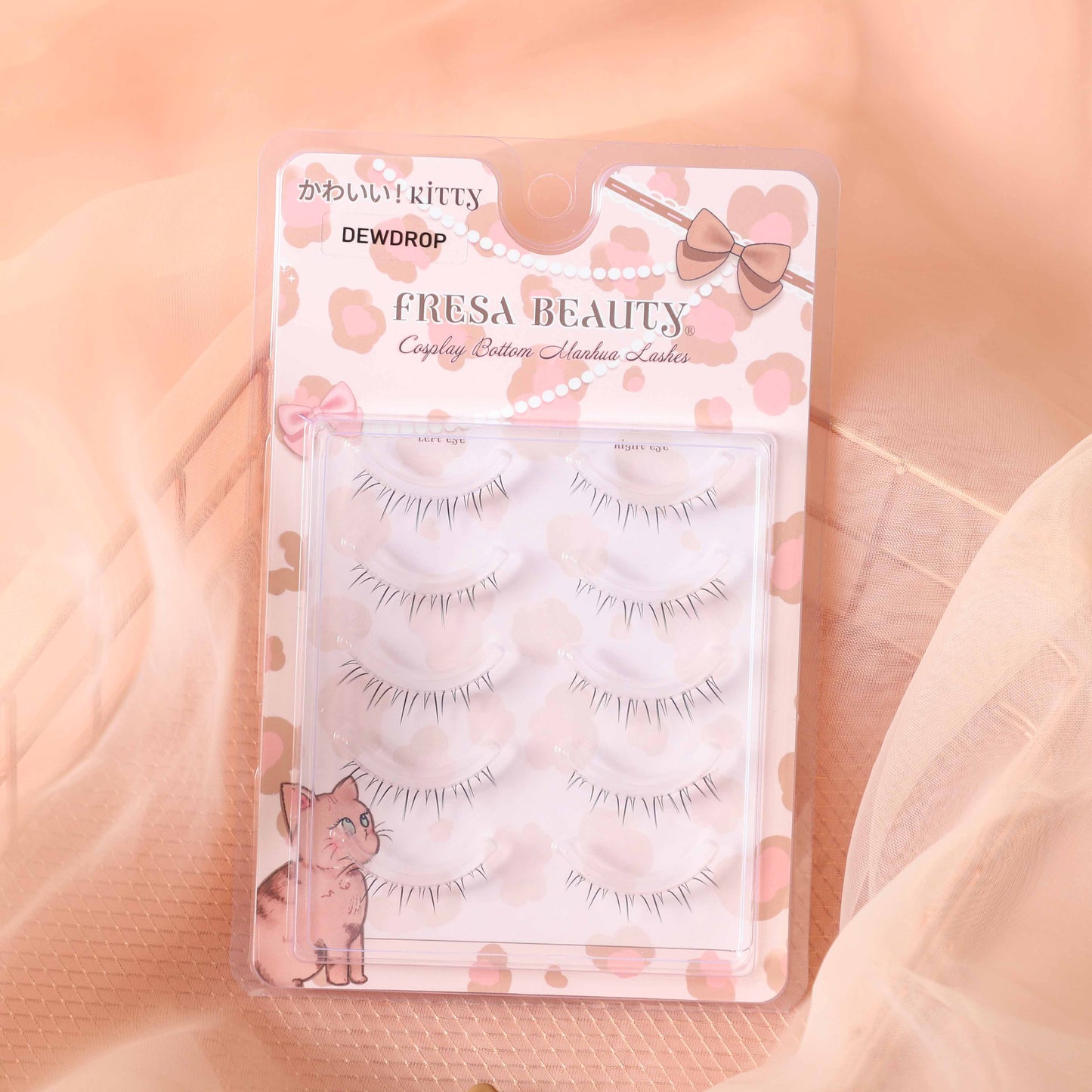 Fresa Beauty bottom false eyelashes packaging with kitty design on a soft peach background